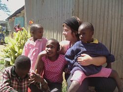A Volunteer plays with orphanage children in Kenya.